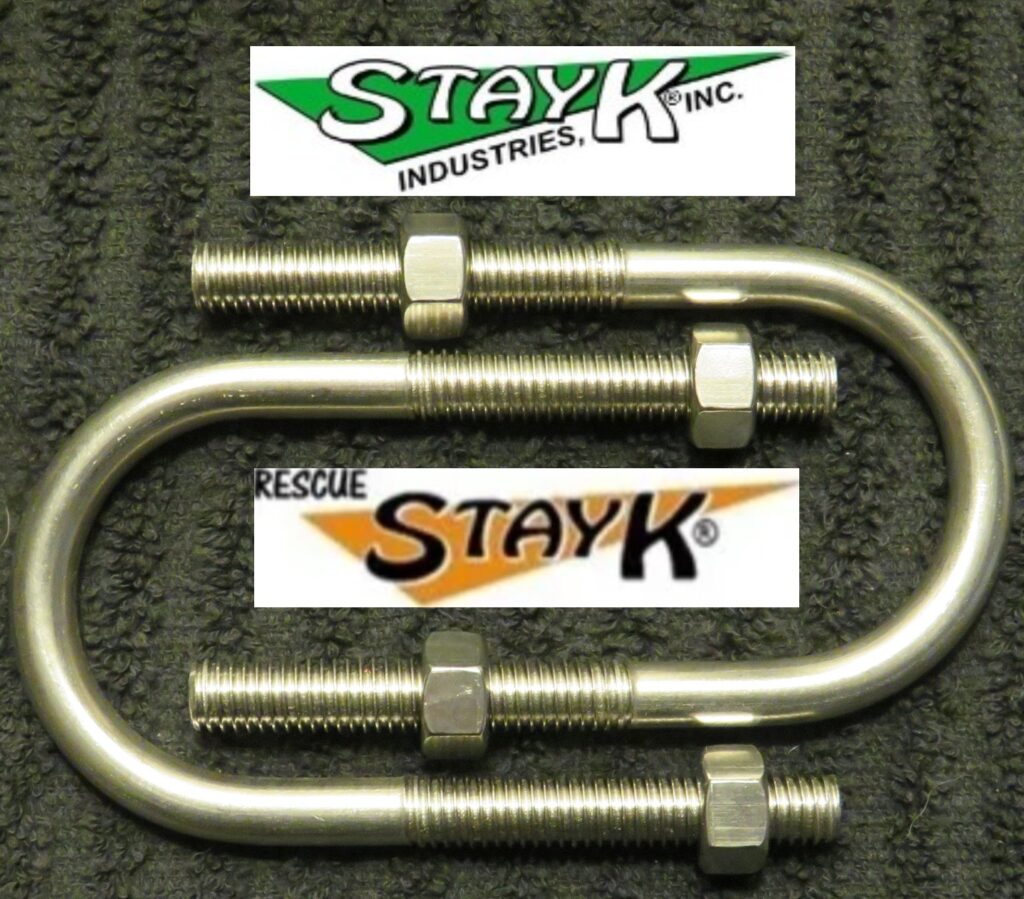 Metal U-bolt with nuts, branded by StayK Industries, placed on a textured black surface. Ideal for industrial or rescue applications.